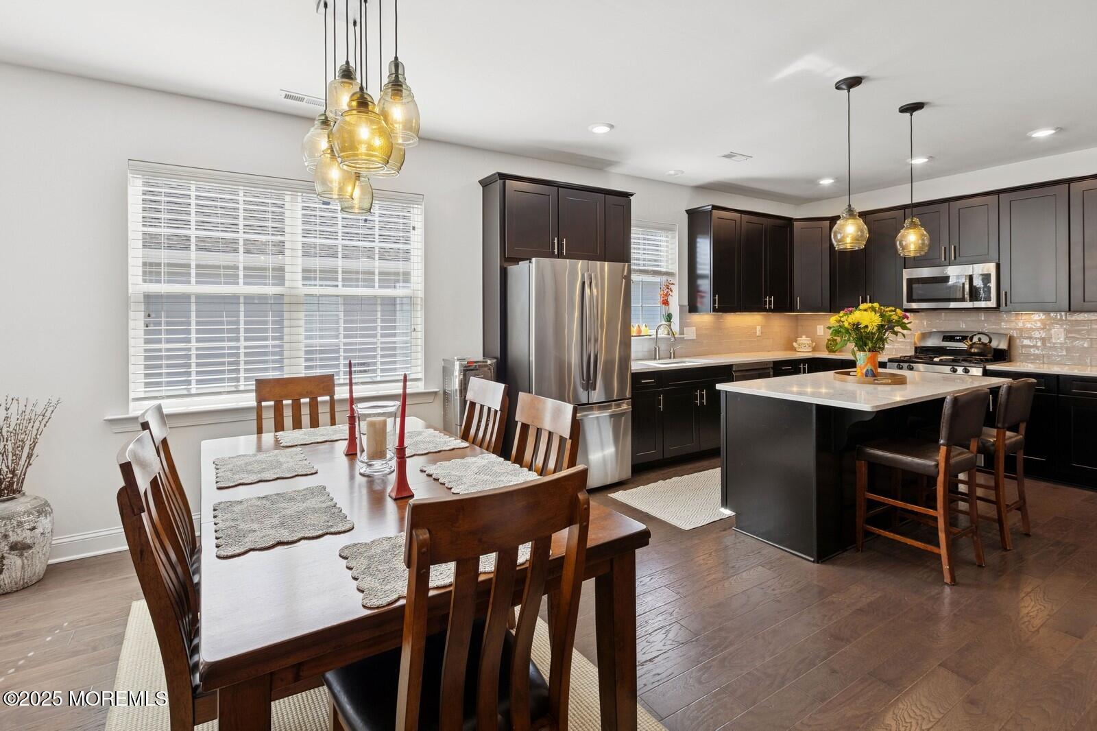 60 Butler Drive Barnegat, NJ 08005 - Photo 16 of 59 a kitchen with stainless steel appliances granite countertop a stove a refrigerator a kitchen island a dining table and chairs