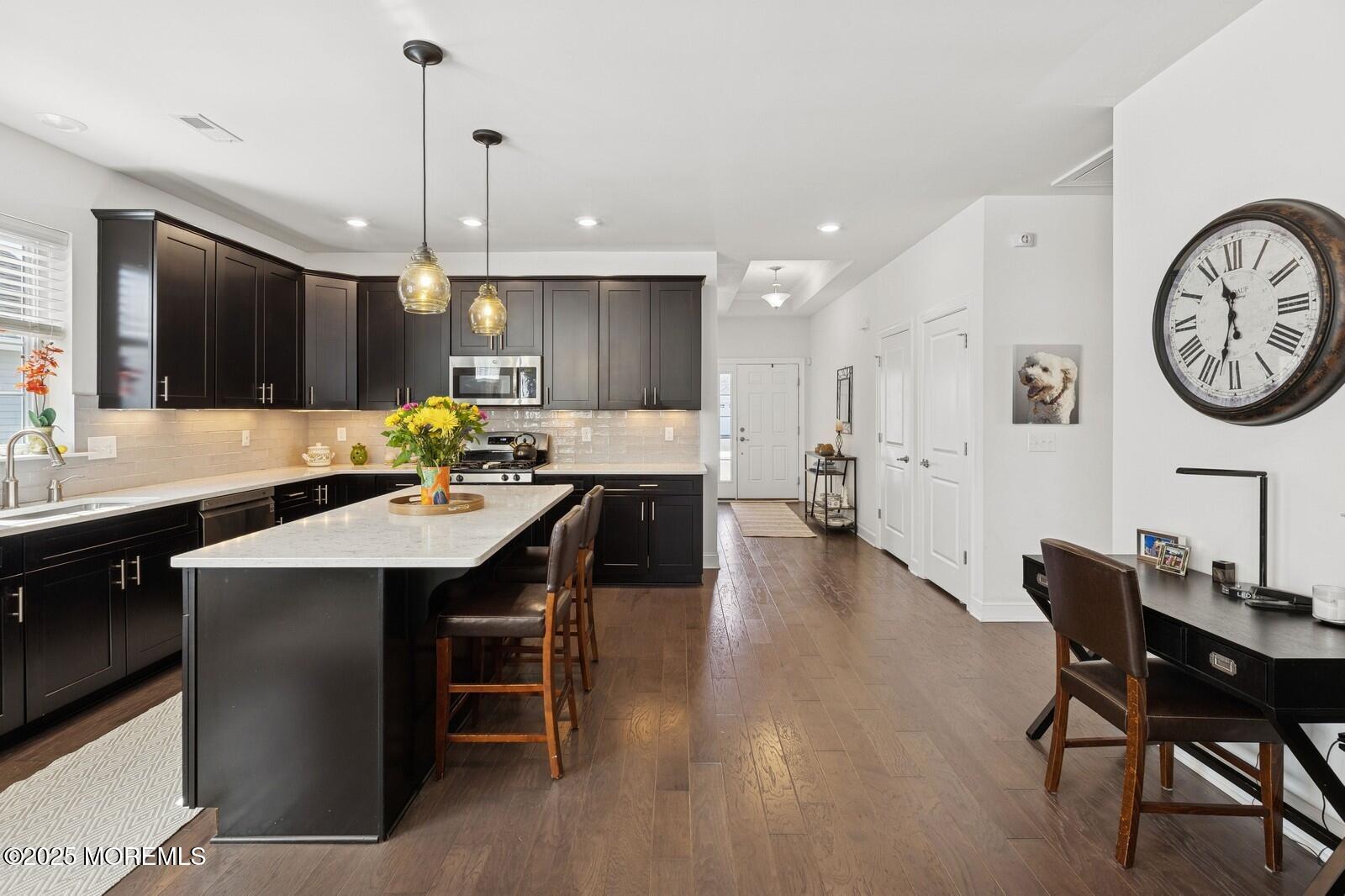60 Butler Drive Barnegat, NJ 08005 - Photo 17 of 59 a open kitchen with a dining table chairs and white cabinets