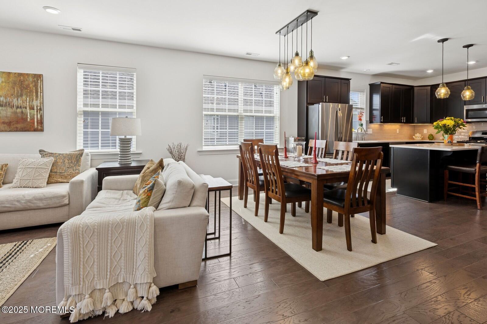 60 Butler Drive Barnegat, NJ 08005 - Photo 25 of 59 a living room with furniture a dining table and a chandelier