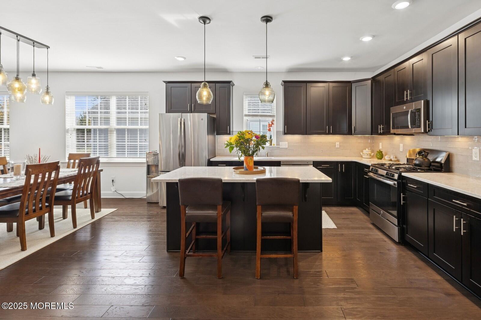 60 Butler Drive Barnegat, NJ 08005 - Photo 7 of 59 a kitchen with stainless steel appliances kitchen island granite countertop a sink a stove a dining table and chairs