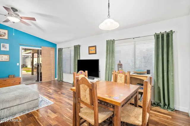 a living room with furniture a large window and a table