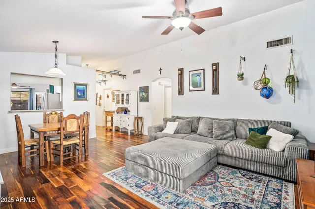 a living room with furniture and wooden floor