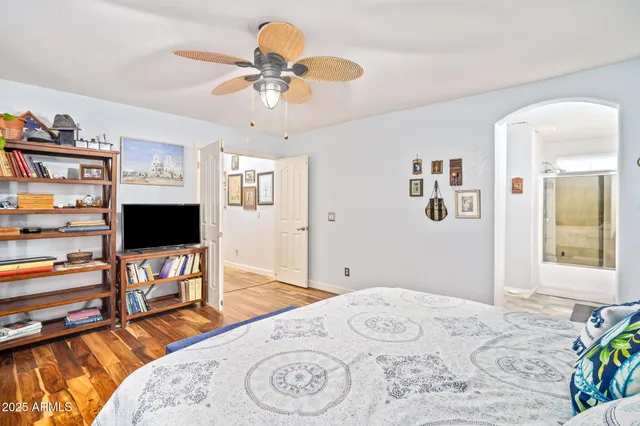 a bedroom with a bed and a flat screen tv