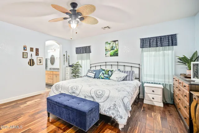 a bedroom with a bed couch and a window