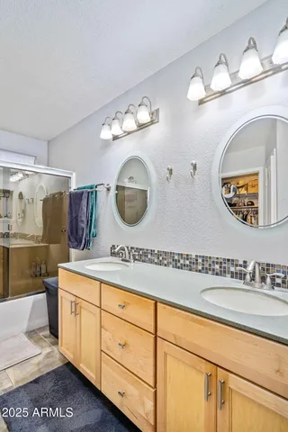 a spacious bathroom with a double vanity sink and a mirror