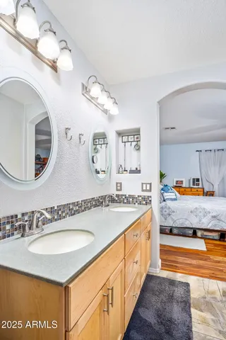 a spacious bathroom with a granite countertop sink and a mirror