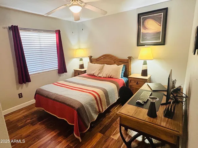 a bedroom with a bed and wooden floor