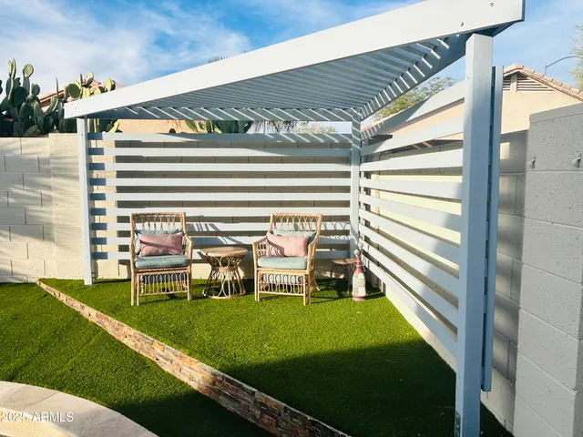 a view of a chair and table on the patio