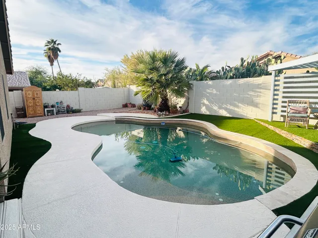 a view of a swimming pool with a yard