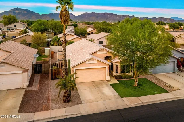 an aerial view of a house with a yard