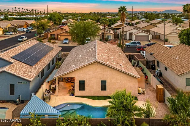 an aerial view of a house with a yard