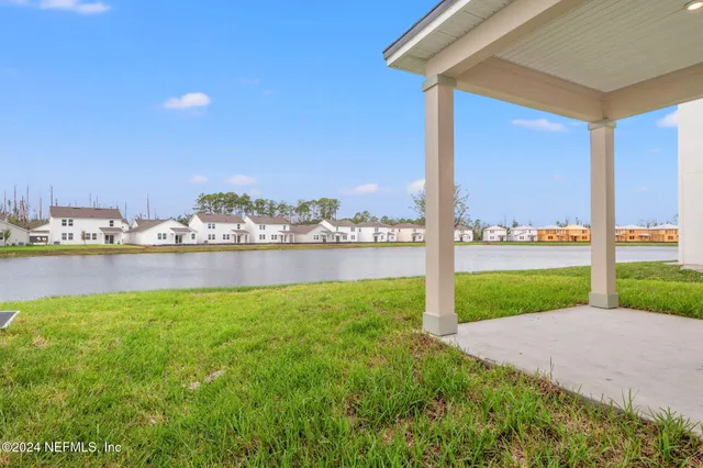 a view of a house with a yard and sitting area