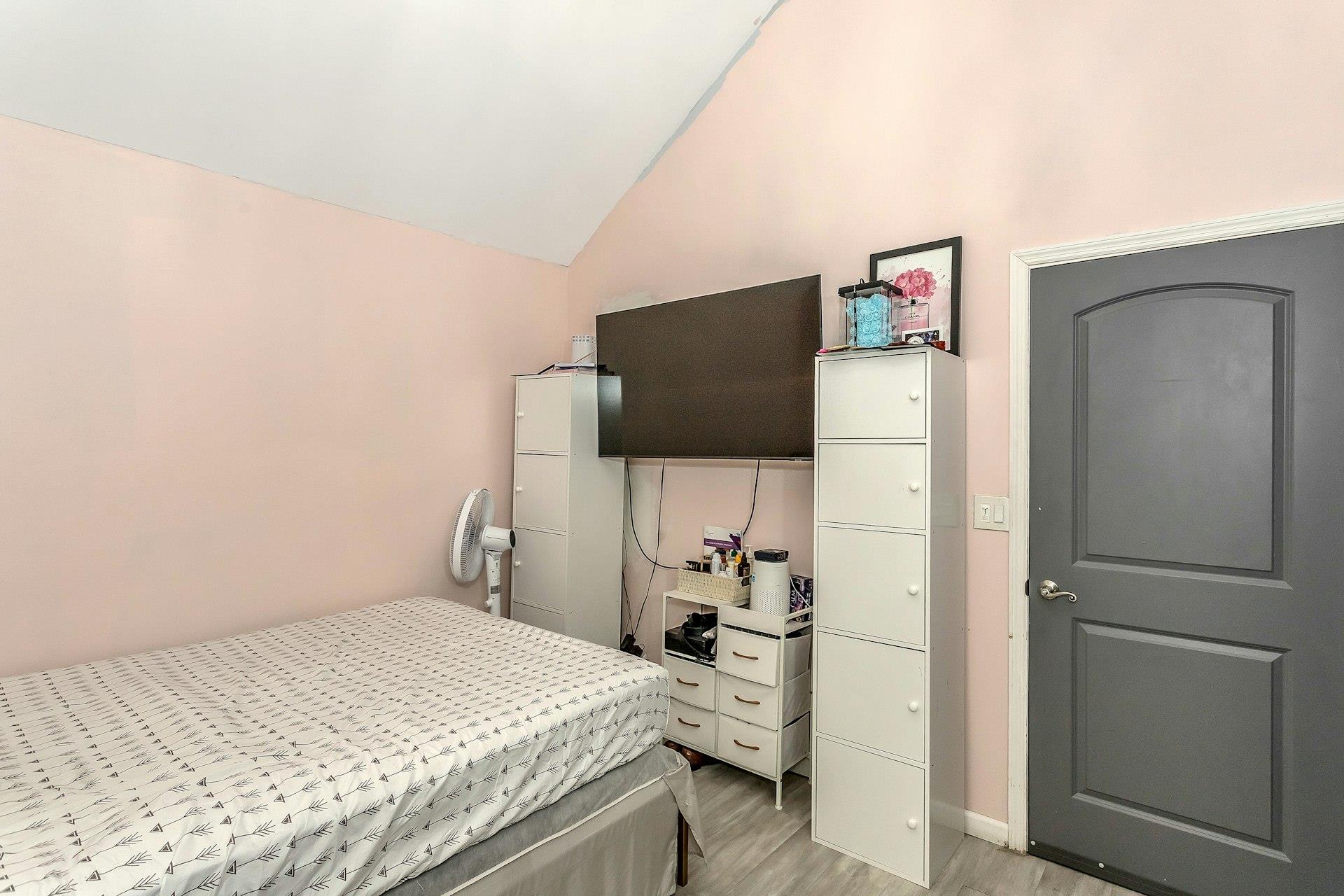 111-32 147th Street Queens, NY 11435 - Photo 10 of 24 Bedroom with light wood-type flooring and lofted ceiling
