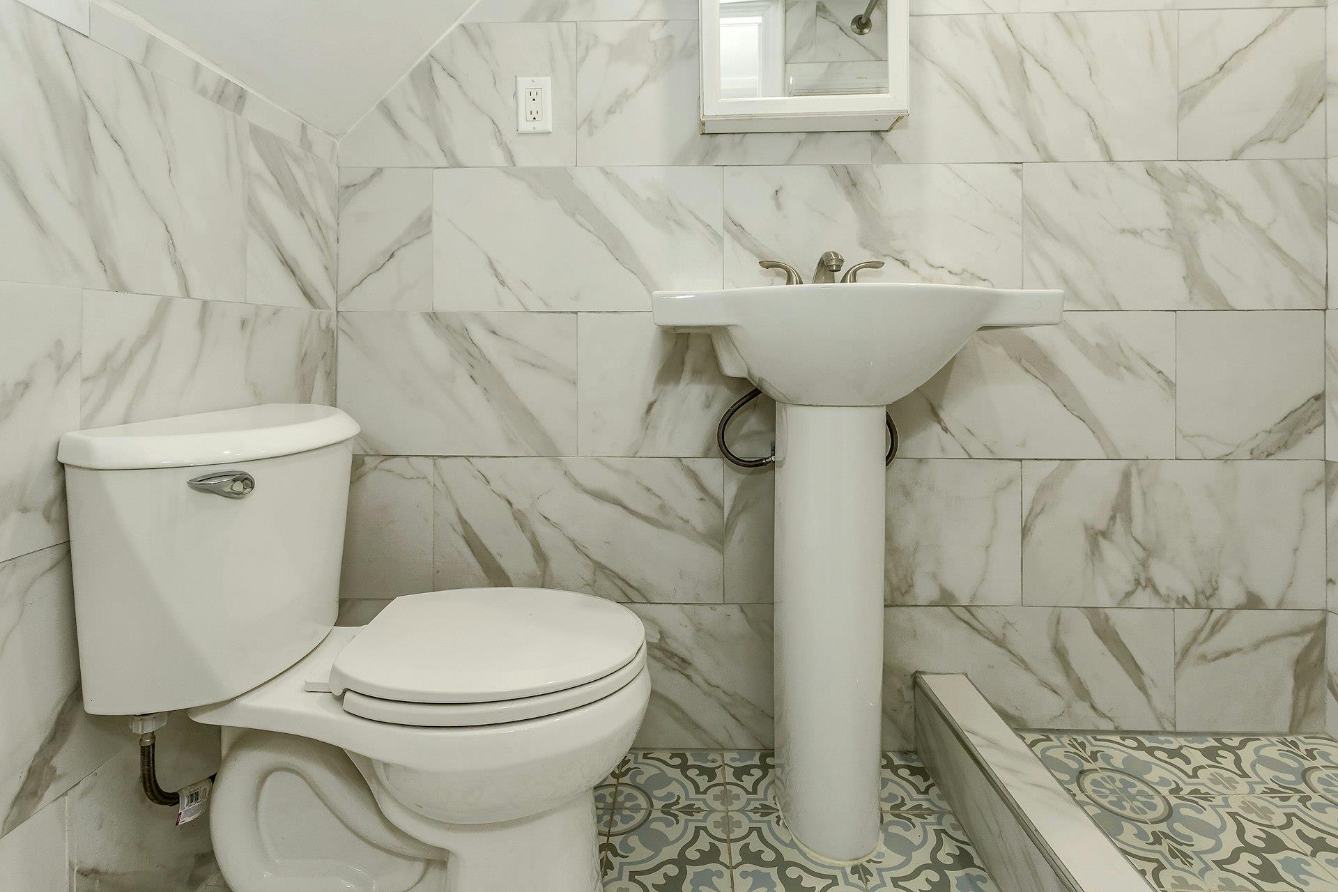 111-32 147th Street Queens, NY 11435 - Photo 12 of 24 Full bath with a stall shower and toilet