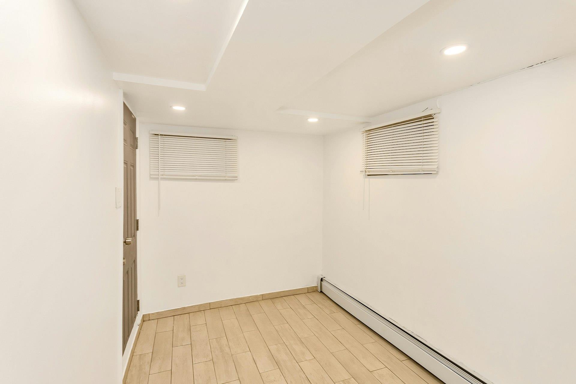 111-32 147th Street Queens, NY 11435 - Photo 19 of 24 Spare room featuring light wood-style flooring, recessed lighting, baseboards, and a baseboard radiator
