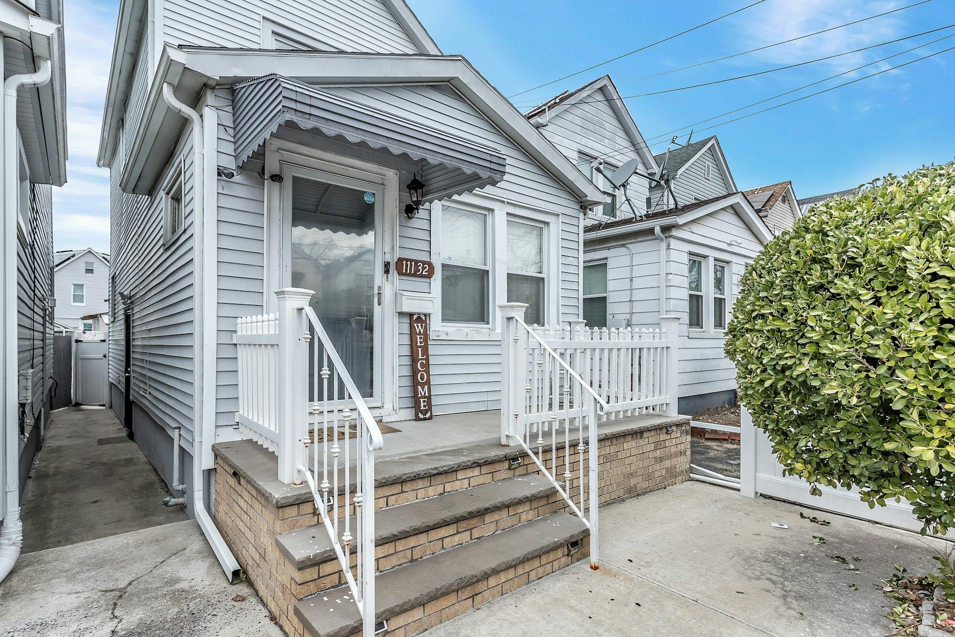 111-32 147th Street Queens, NY 11435 - Photo 2 of 24 View of exterior entry featuring fence