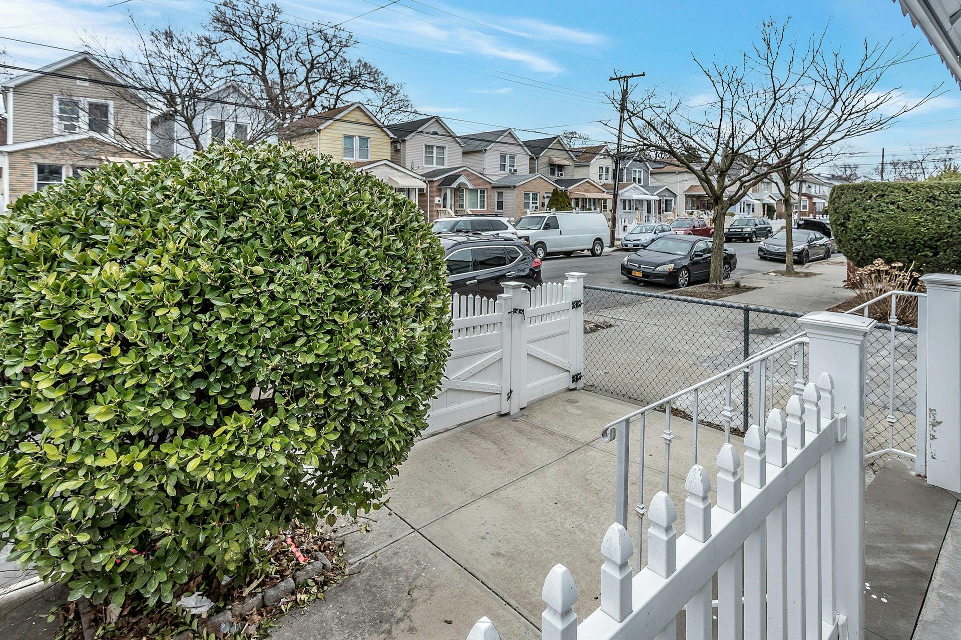 111-32 147th Street Queens, NY 11435 - Photo 3 of 24 View of road with sidewalks, a gate, and a residential view