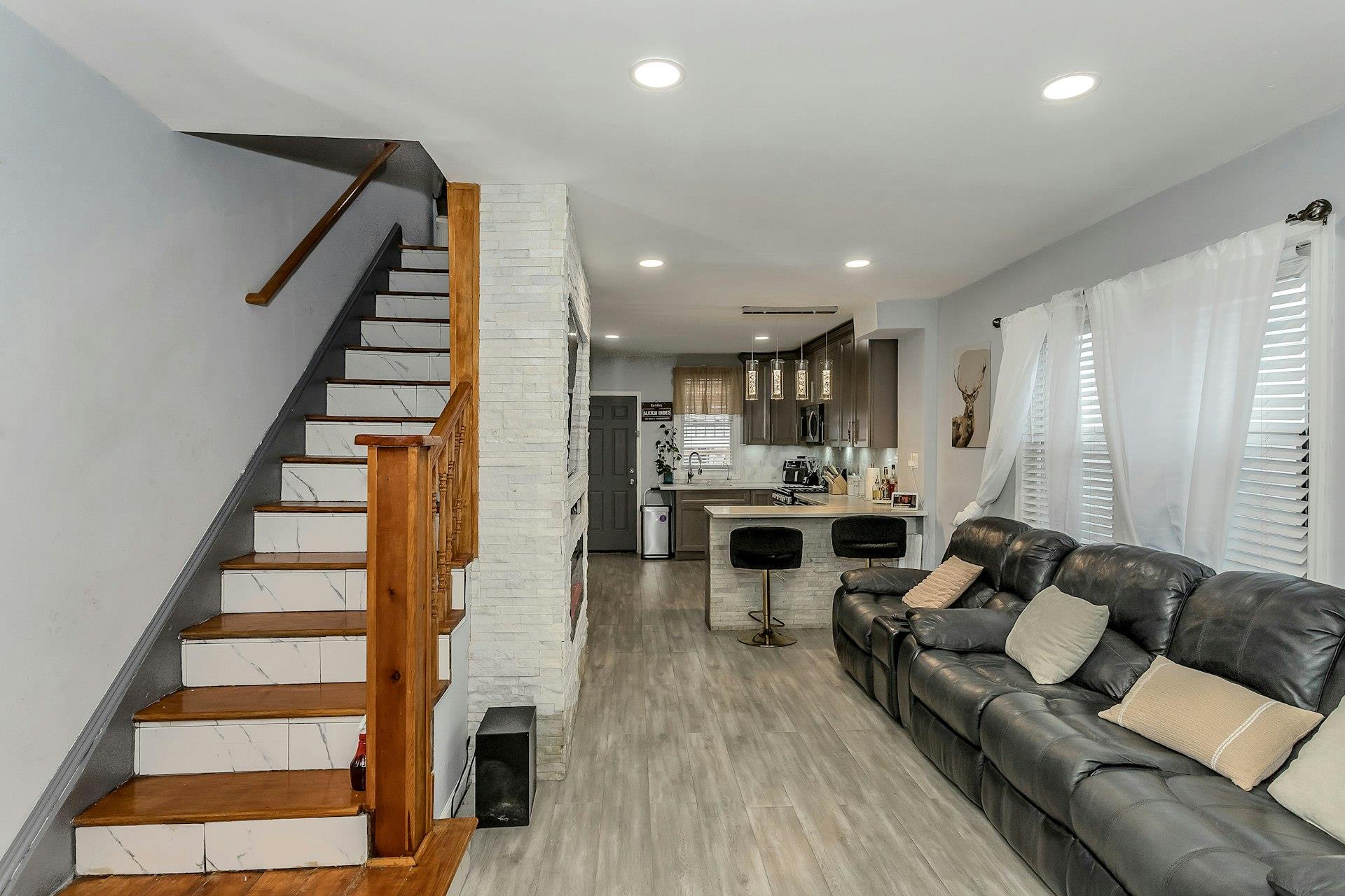 111-32 147th Street Queens, NY 11435 - Photo 4 of 24 Living area with recessed lighting, stairs, and light wood finished floors