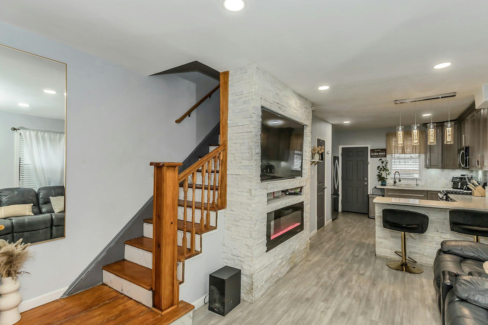 111-32 147th Street Queens, NY 11435 - Photo 24 of 24 Kitchen with light wood-type flooring, open floor plan, stainless steel appliances, a breakfast bar area, and light countertops