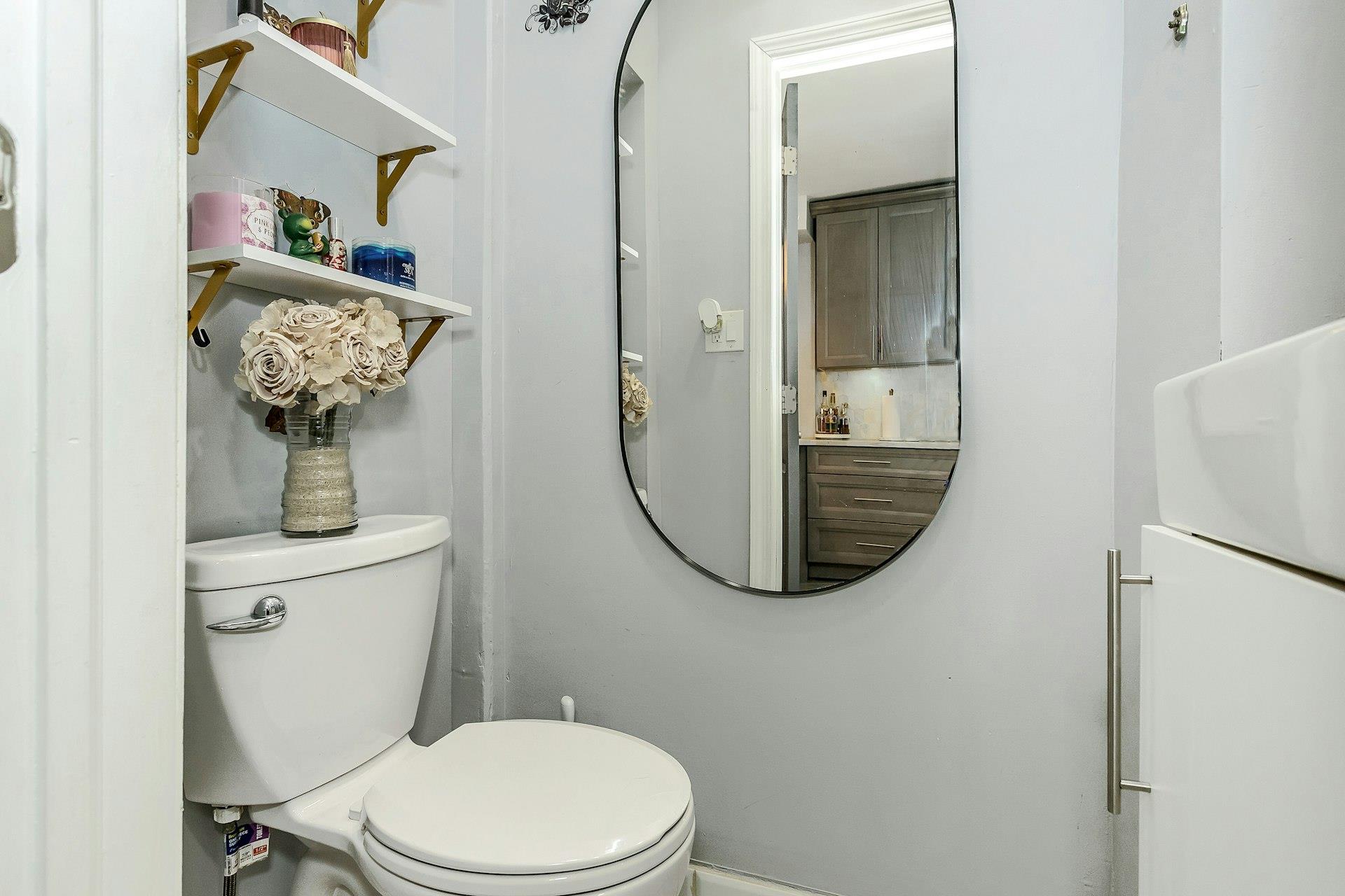 111-32 147th Street Queens, NY 11435 - Photo 7 of 24 Half bath with toilet and sink