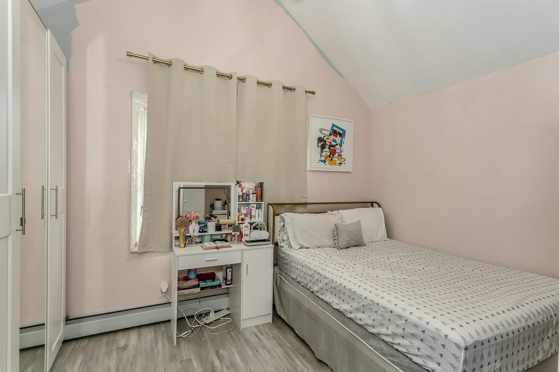 111-32 147th Street Queens, NY 11435 - Photo 8 of 24 Bedroom featuring a baseboard heating unit, light wood-style floors, and vaulted ceiling