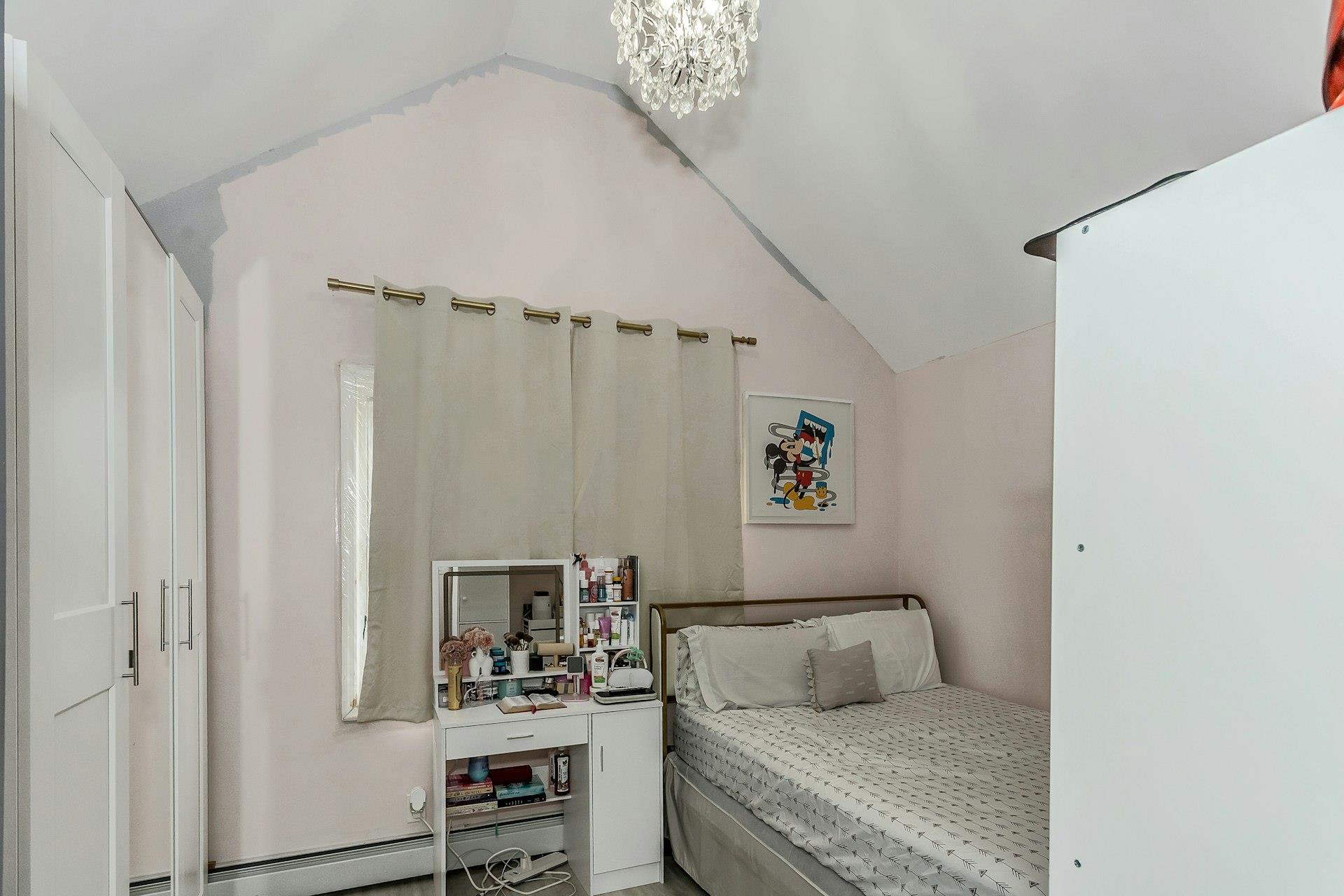 111-32 147th Street Queens, NY 11435 - Photo 9 of 24 Bedroom featuring an inviting chandelier and lofted ceiling