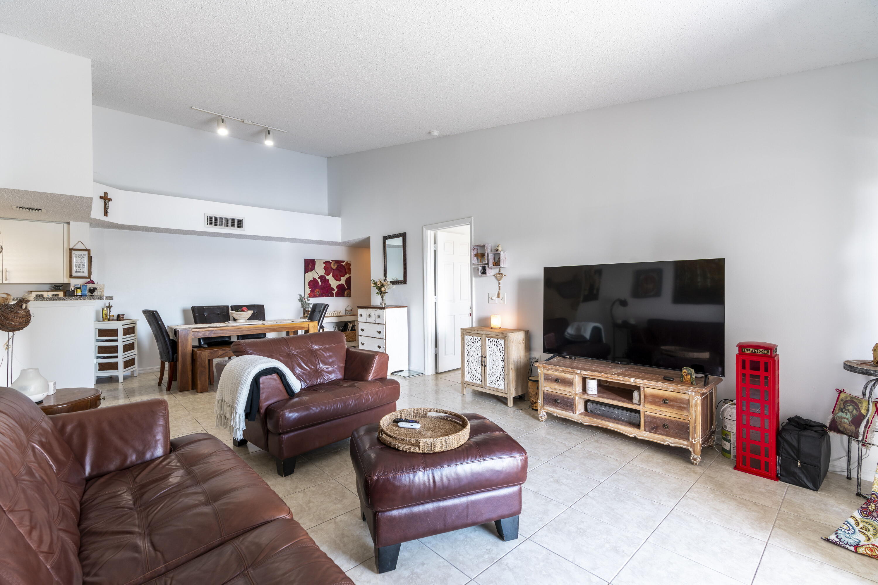 5031 Wiles Road, Unit 304 Coconut Creek, FL 33073 - Photo 17 of 55 a living room with furniture and a flat screen tv