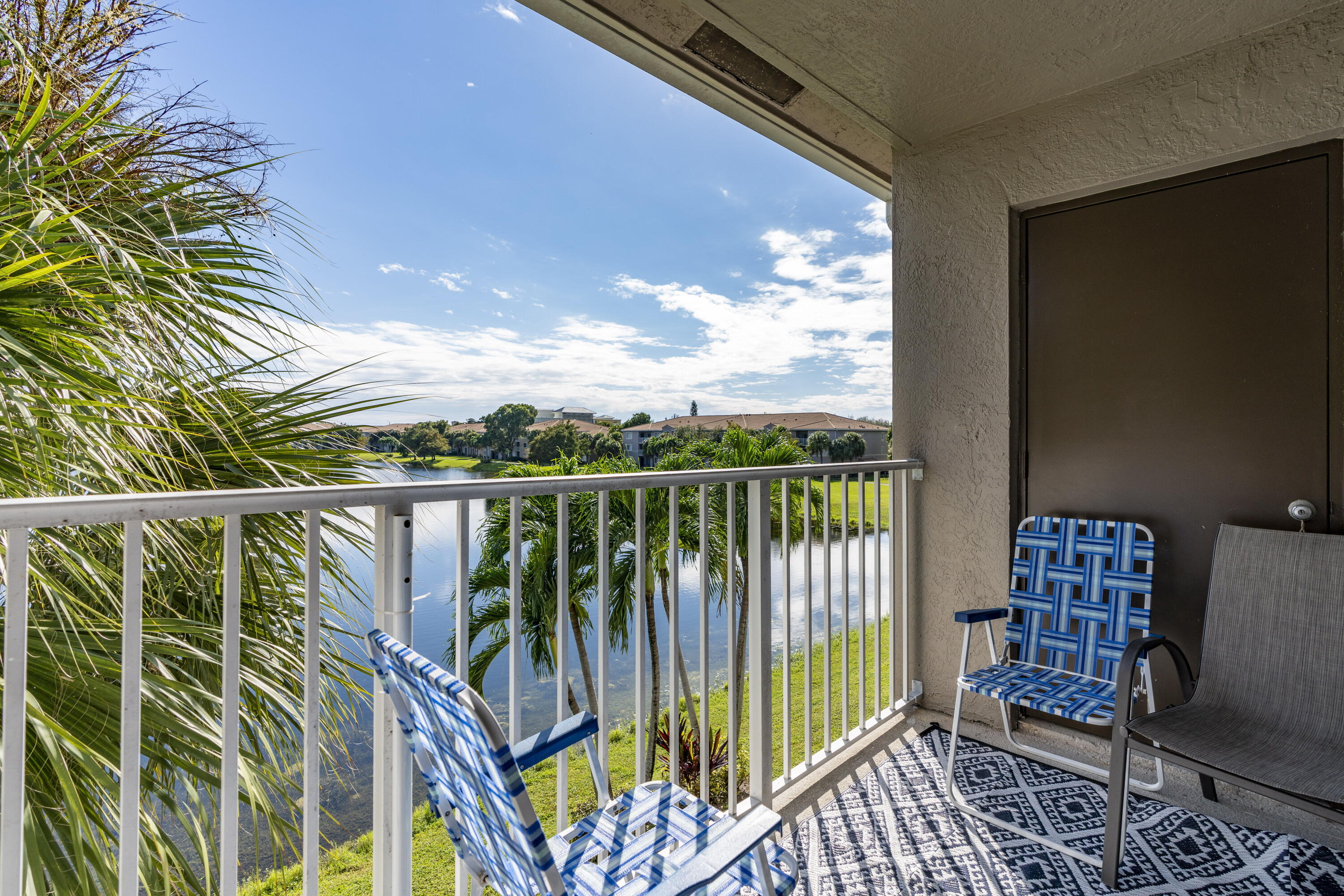 5031 Wiles Road, Unit 304 Coconut Creek, FL 33073 - Photo 21 of 55 a balcony with chairs