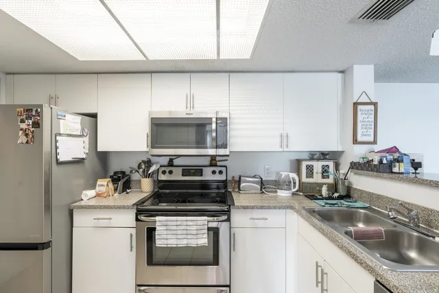 a kitchen with a stove microwave and sink