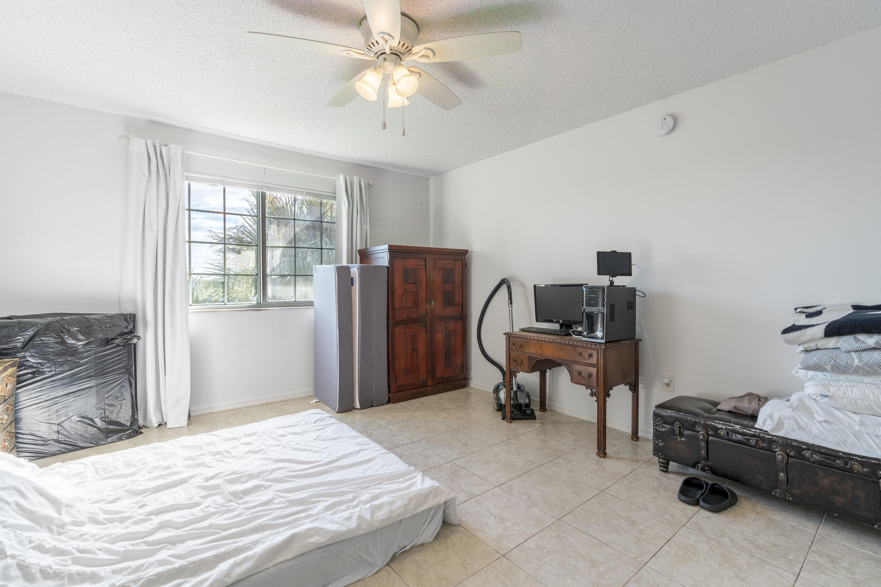 5031 Wiles Road, Unit 304 Coconut Creek, FL 33073 - Photo 34 of 55 a bedroom with a bed and a chandelier