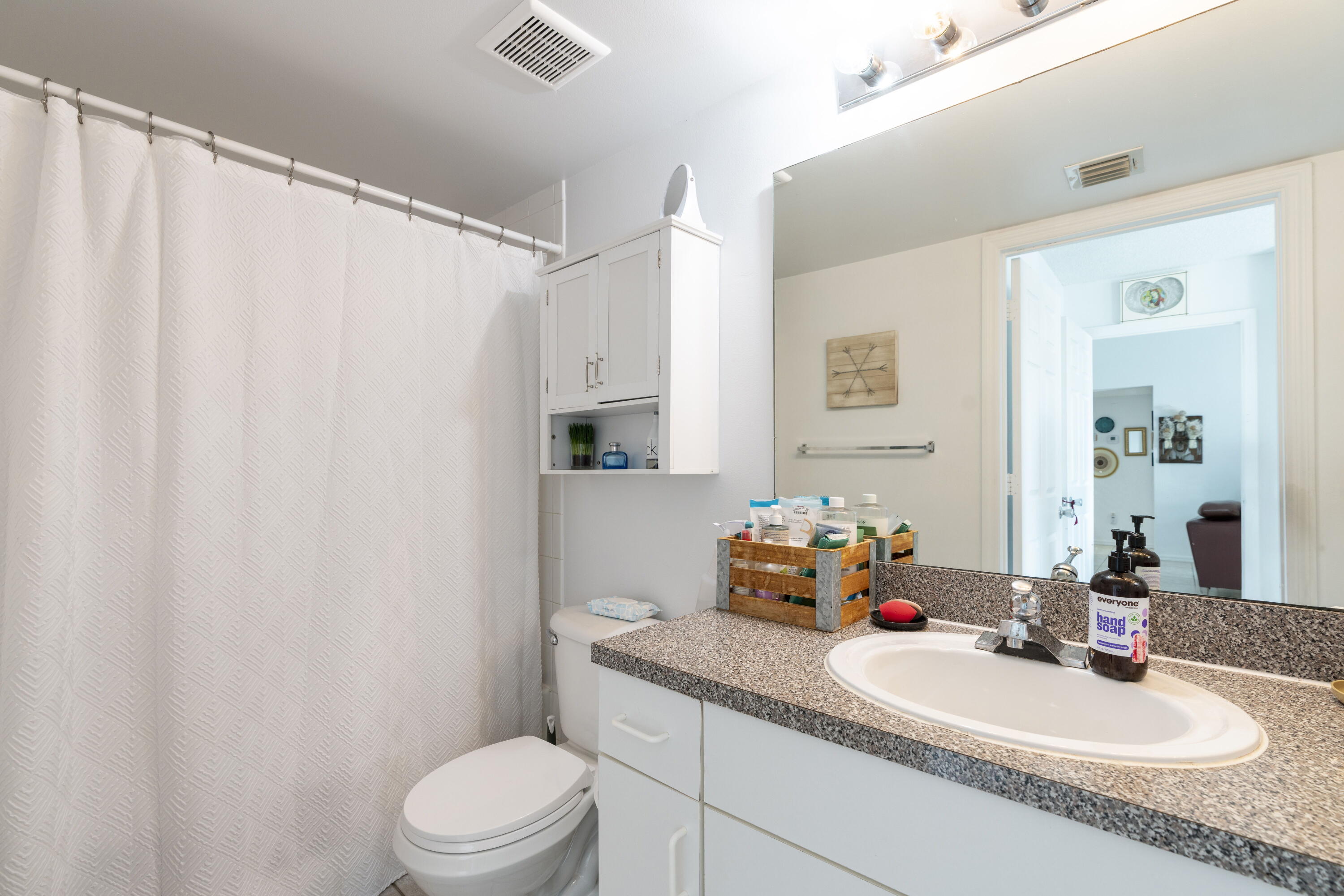 5031 Wiles Road, Unit 304 Coconut Creek, FL 33073 - Photo 37 of 55 a bathroom with a granite countertop sink vanity mirror and toilet