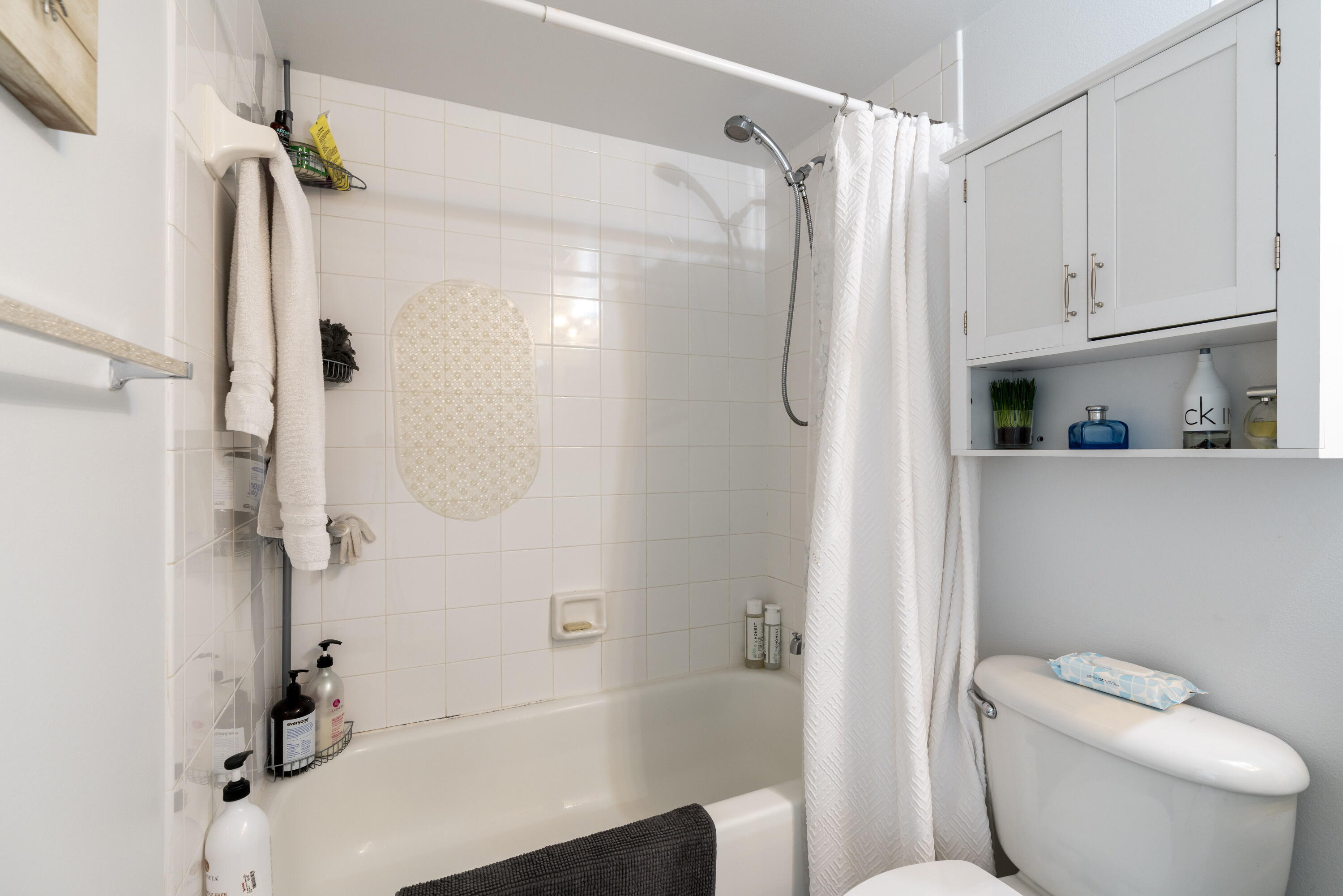 5031 Wiles Road, Unit 304 Coconut Creek, FL 33073 - Photo 40 of 55 a bathroom with a shower a toilet and a sink