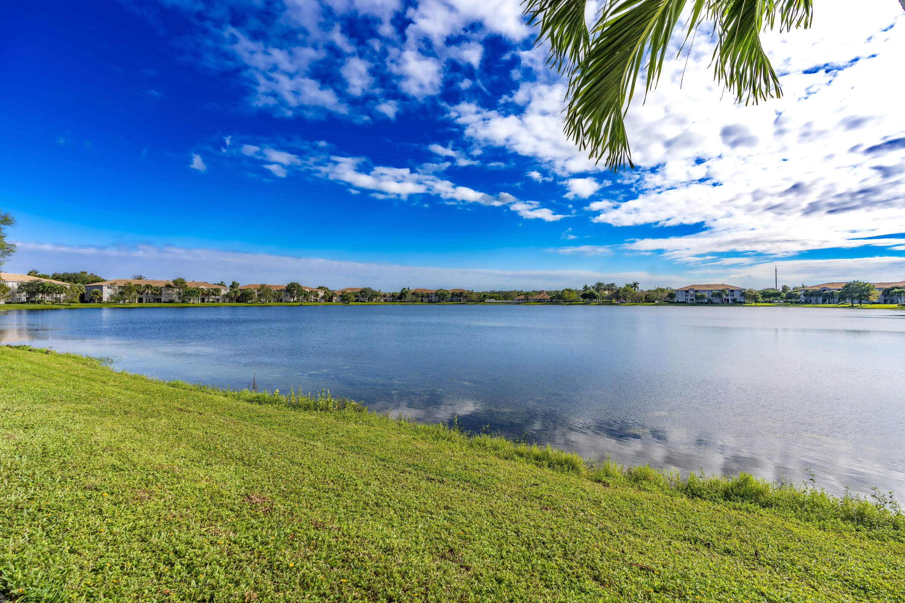 5031 Wiles Road, Unit 304 Coconut Creek, FL 33073 - Photo 4 of 55 a view of a lake with a beach