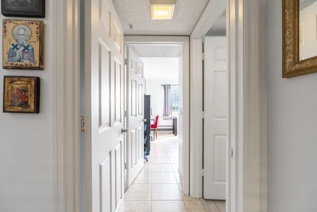 a bathroom with a granite countertop sink mirror and toilet