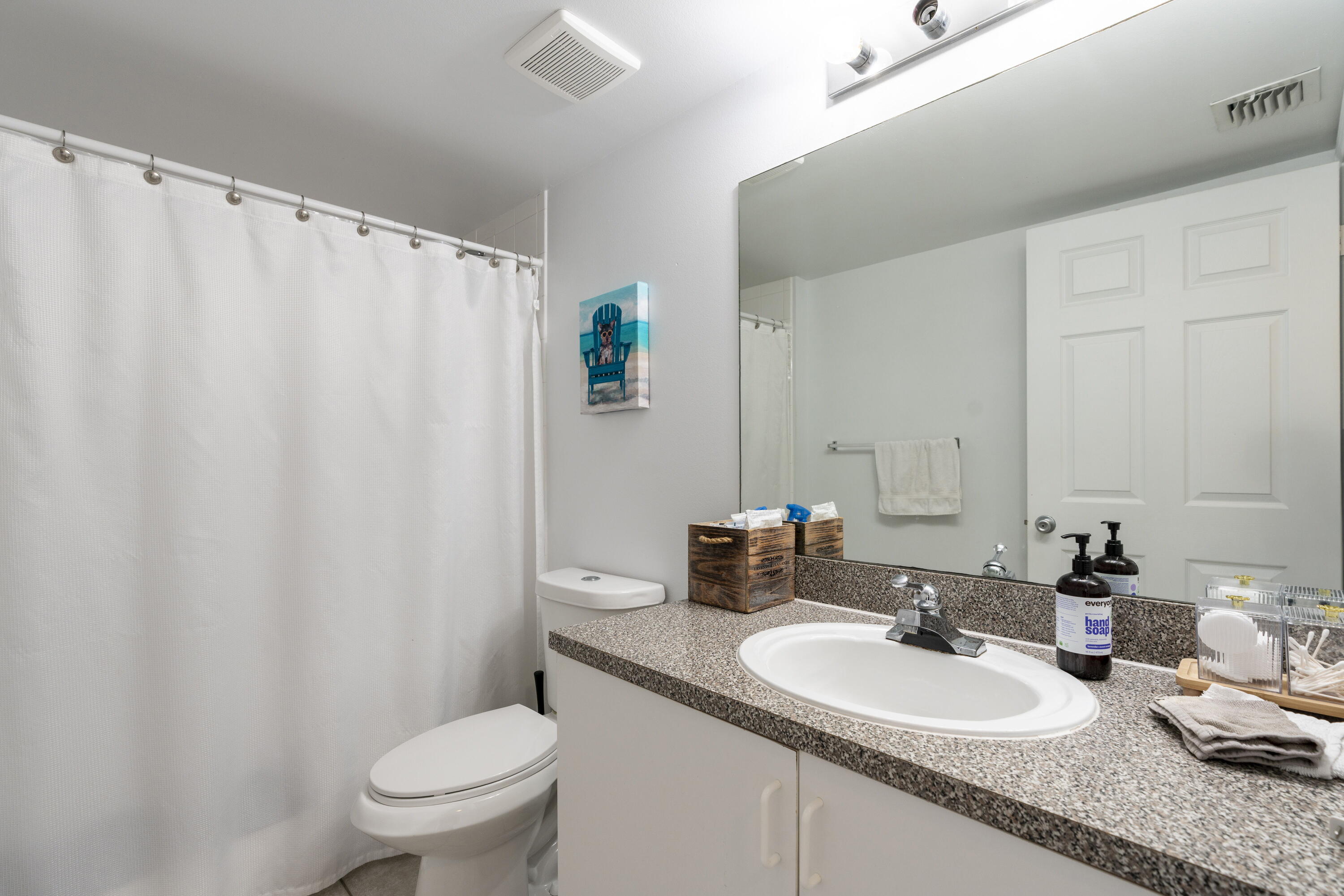 5031 Wiles Road, Unit 304 Coconut Creek, FL 33073 - Photo 45 of 55 a bathroom with a granite countertop sink and a mirror