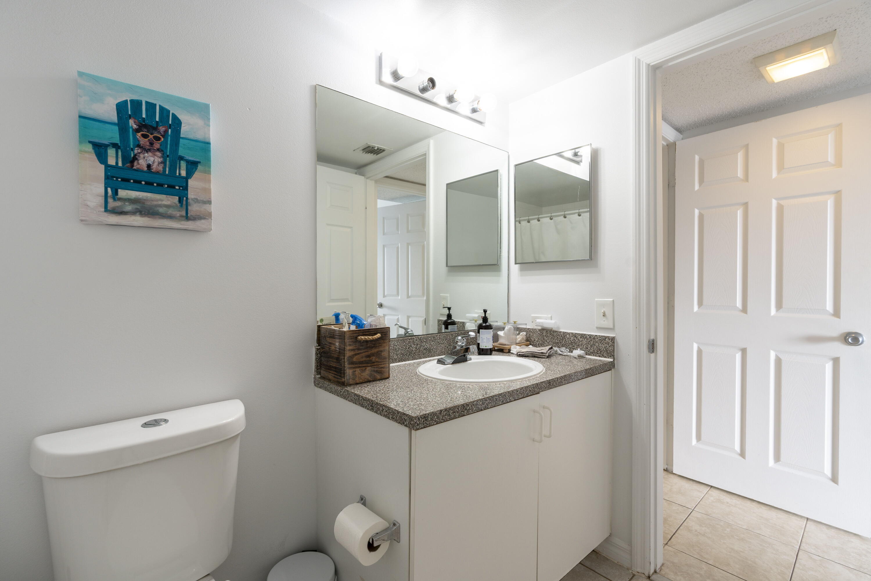 5031 Wiles Road, Unit 304 Coconut Creek, FL 33073 - Photo 46 of 55 a bathroom with a granite countertop sink mirror and toilet