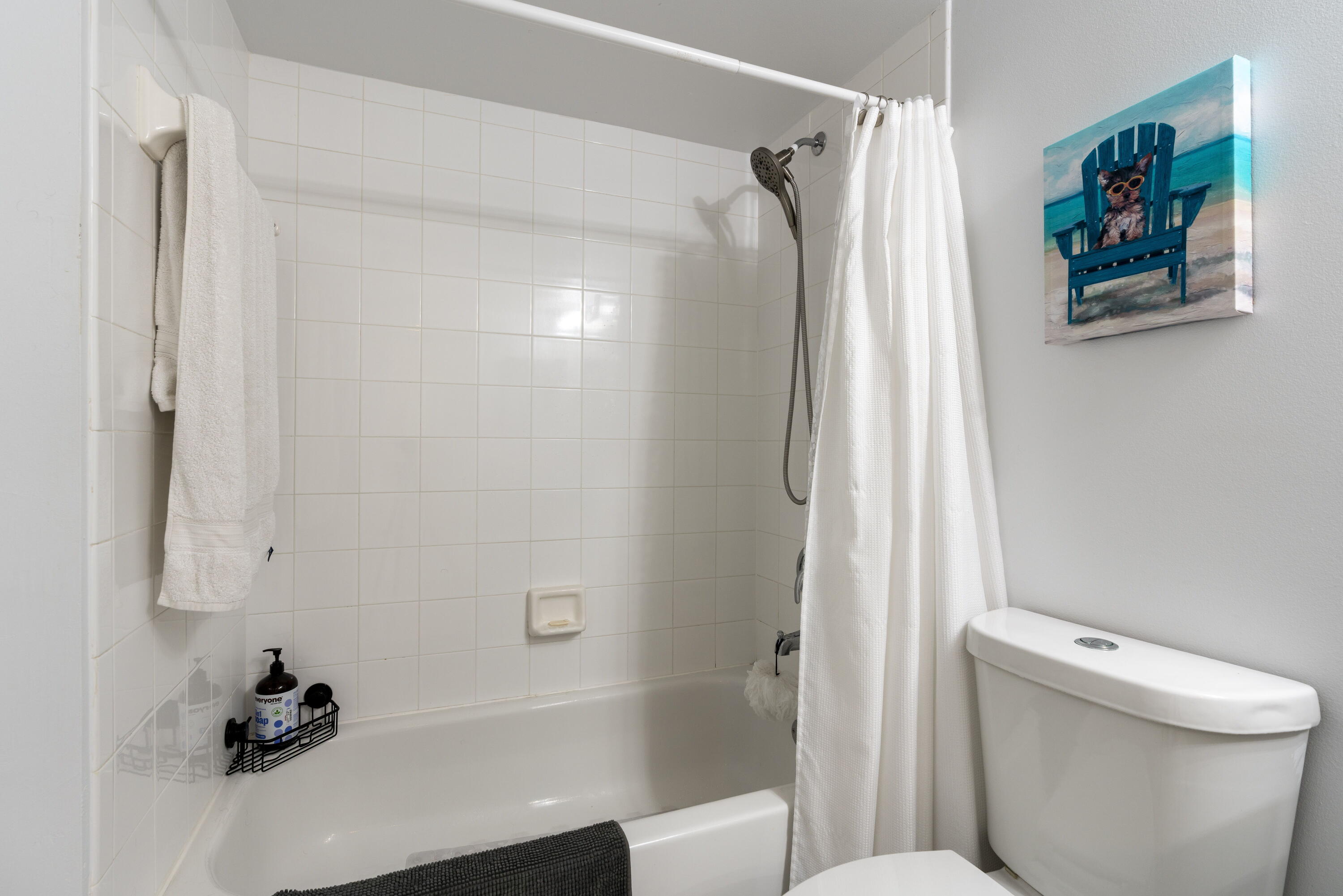 5031 Wiles Road, Unit 304 Coconut Creek, FL 33073 - Photo 47 of 55 a bathroom with a toilet and a shower curtain