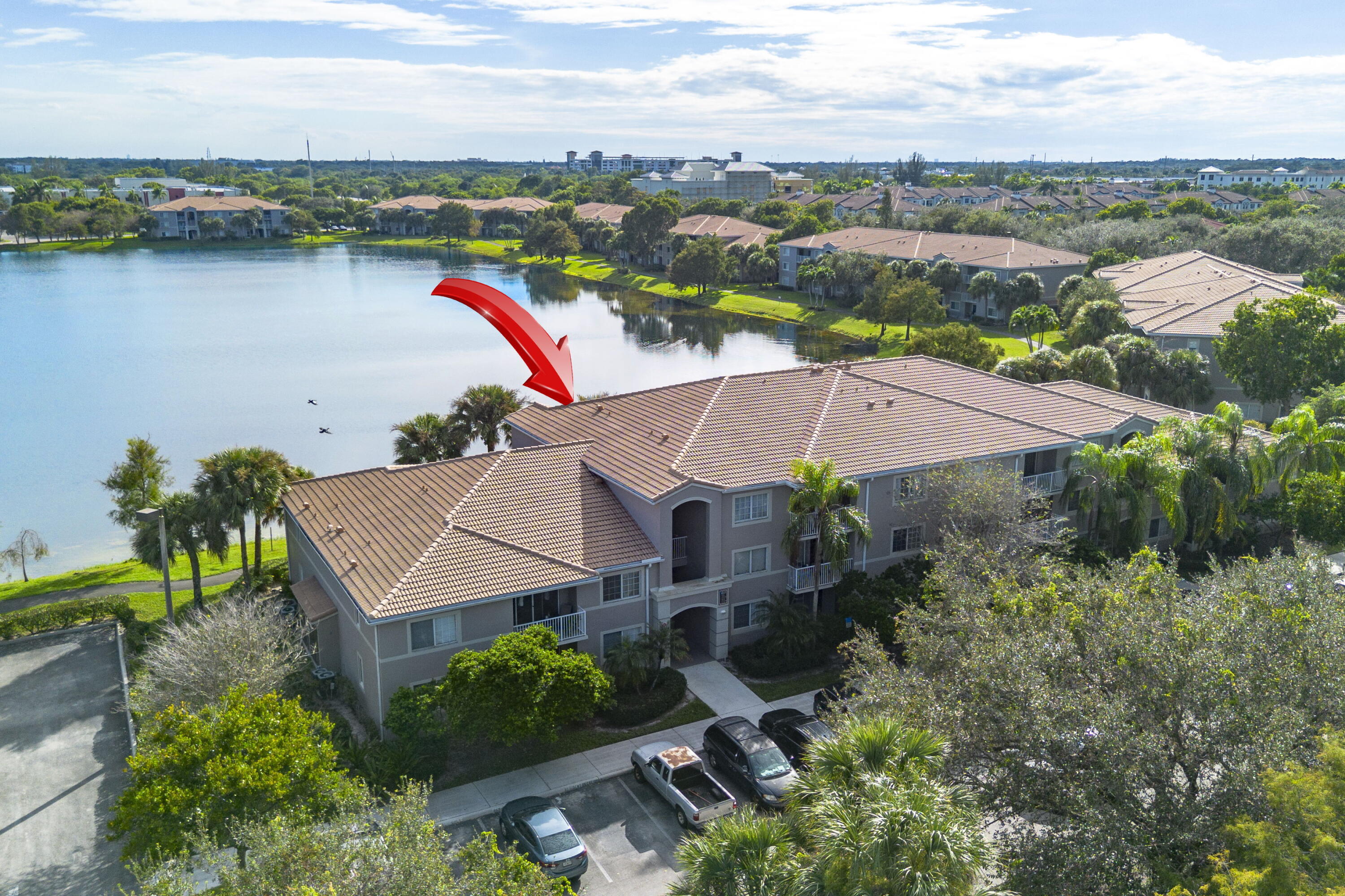 5031 Wiles Road, Unit 304 Coconut Creek, FL 33073 - Photo 49 of 55 an aerial view of a house with a lake view and mountain view in back