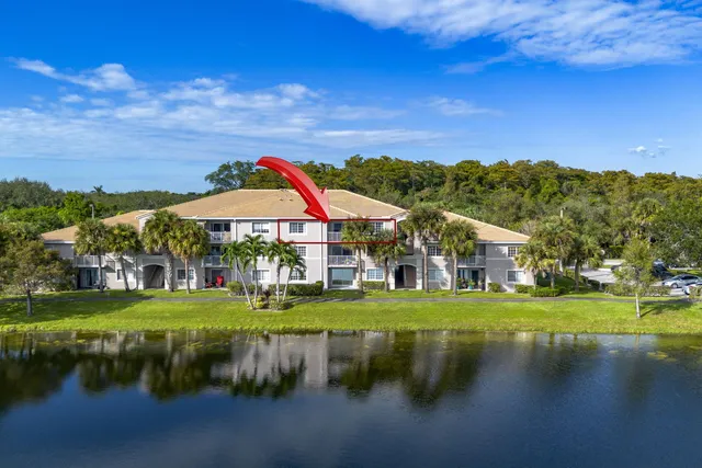 an aerial view of a house with swimming pool and patio