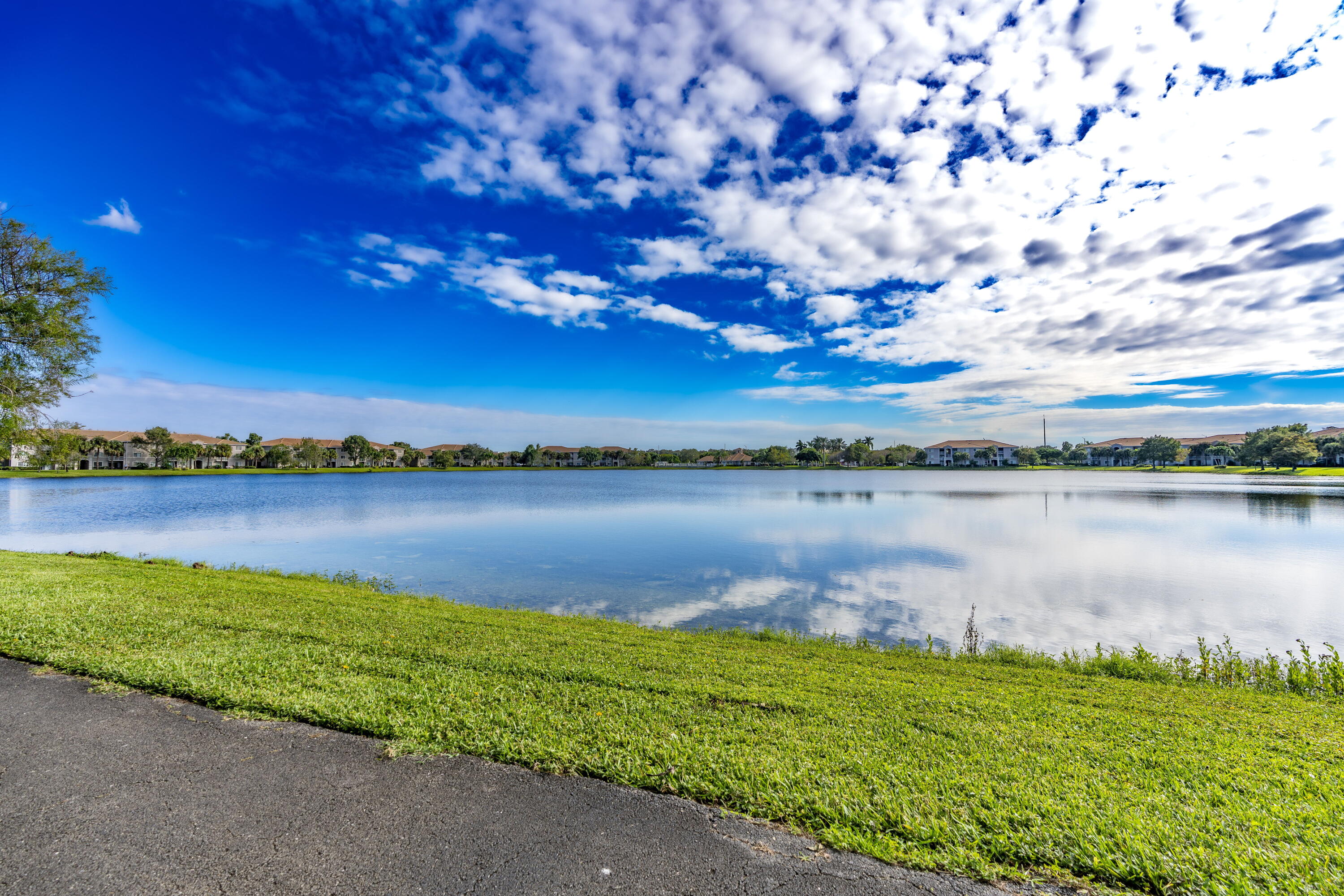 5031 Wiles Road, Unit 304 Coconut Creek, FL 33073 - Photo 5 of 55 a view of a lake from a yard