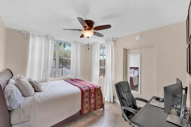 a bedroom with a bed a desk and chair