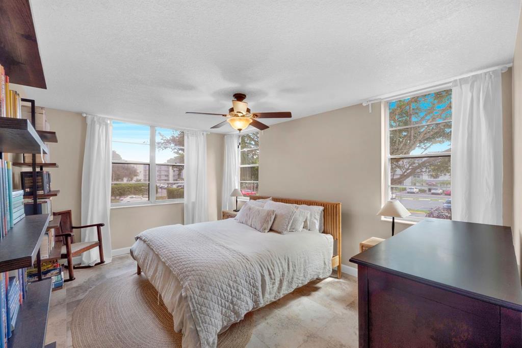 9330 Lagoon Place, Unit 209 Davie, FL 33324 - Photo 12 of 14 a bedroom with a bed and a table