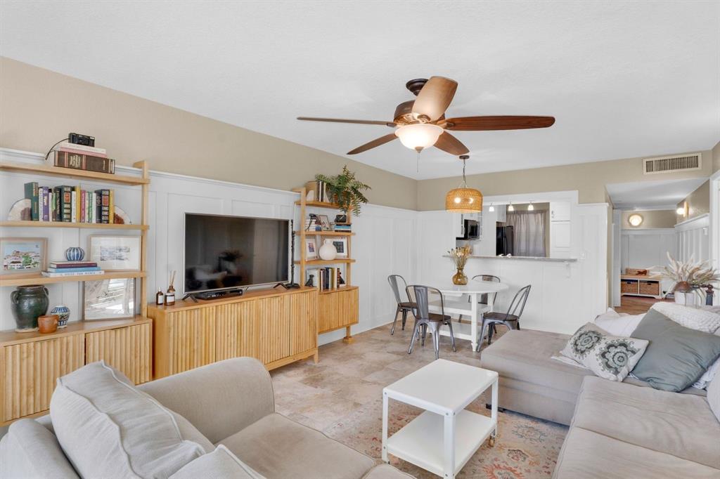 9330 Lagoon Place, Unit 209 Davie, FL 33324 - Photo 13 of 14 a living room with furniture and a flat screen tv