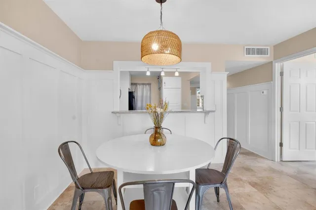a view of a dining room with a table and chairs