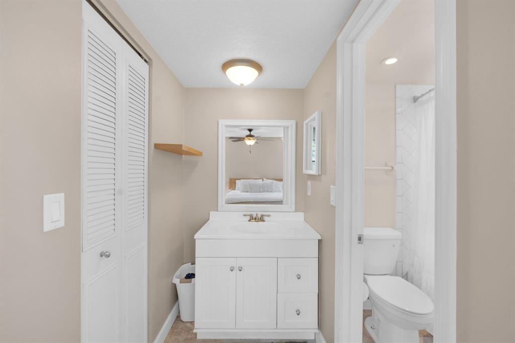 9330 Lagoon Place, Unit 209 Davie, FL 33324 - Photo 8 of 14 a bathroom with a sink a toilet and a mirror