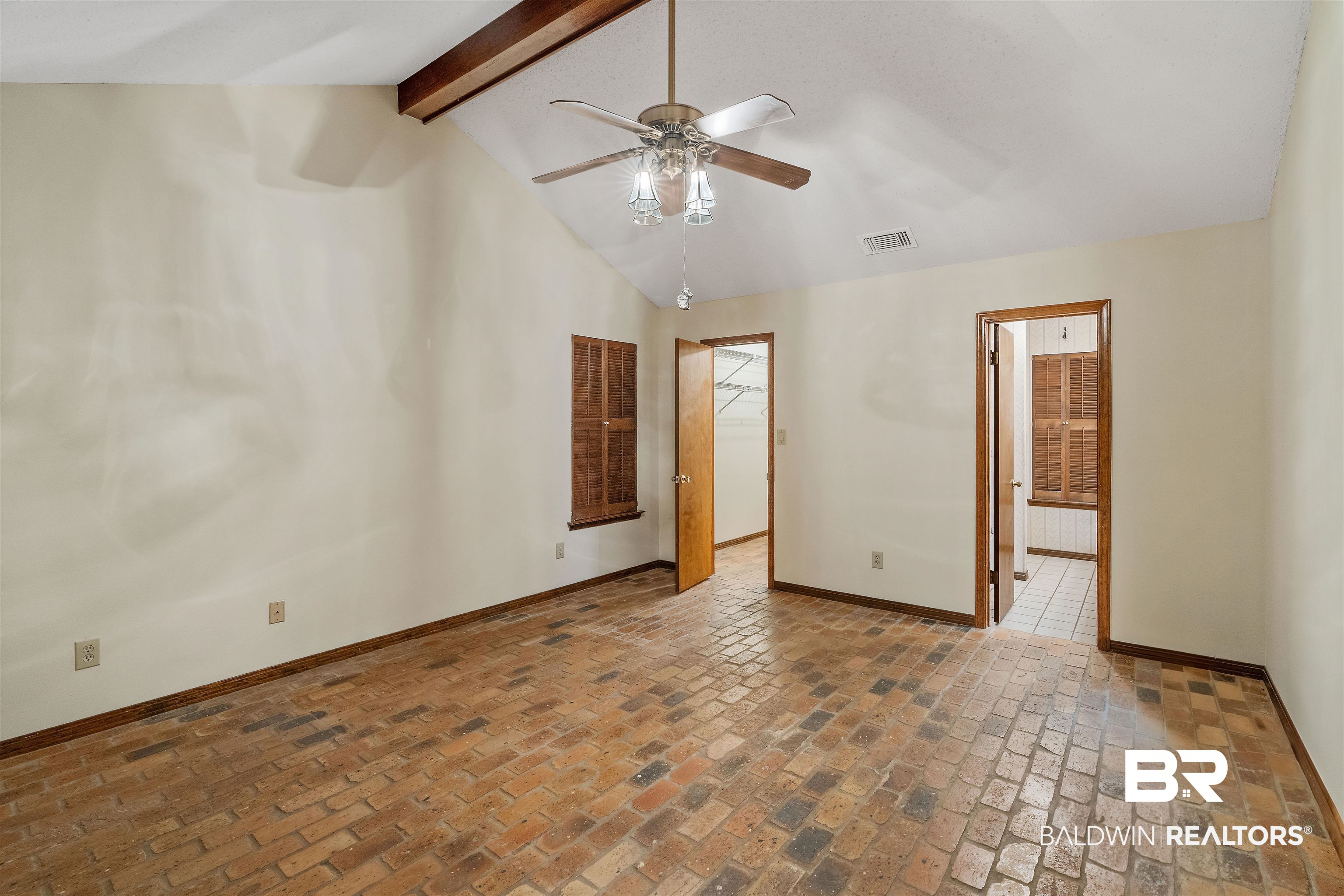 438 Ridgewood Drive Daphne, AL 36526 - Photo 12 of 28 Unfurnished bedroom featuring beam ceiling, high vaulted ceiling, ensuite bathroom, a spacious closet, and ceiling fan