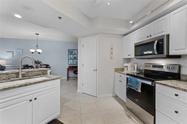 a kitchen with stainless steel appliances granite countertop a sink and stove top oven