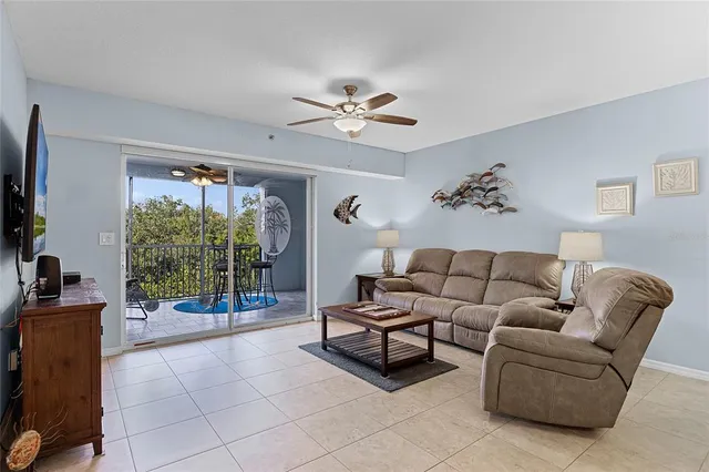 a living room with furniture a chandelier and a large window