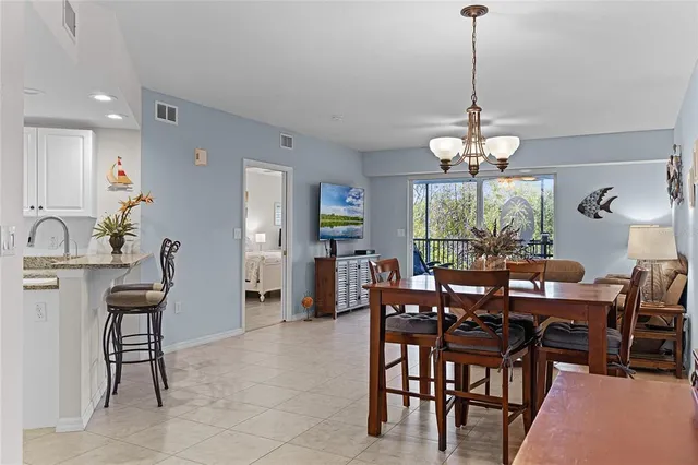a view of a dining room and livingroom furniture and chandelier