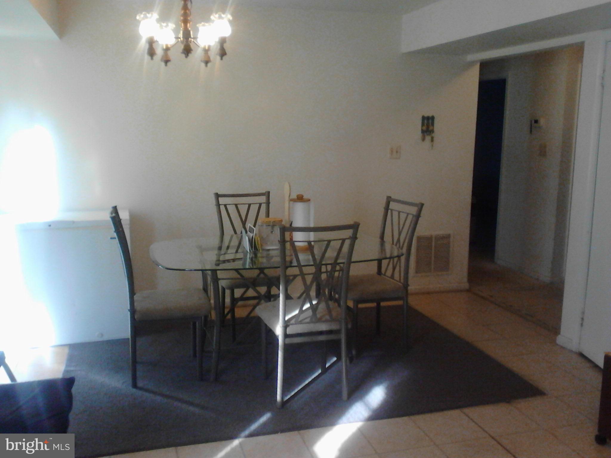 7600 Fox Hunt Court Clinton, MD 20735 - Photo 7 of 13 a view of a dining room with furniture and chandelier